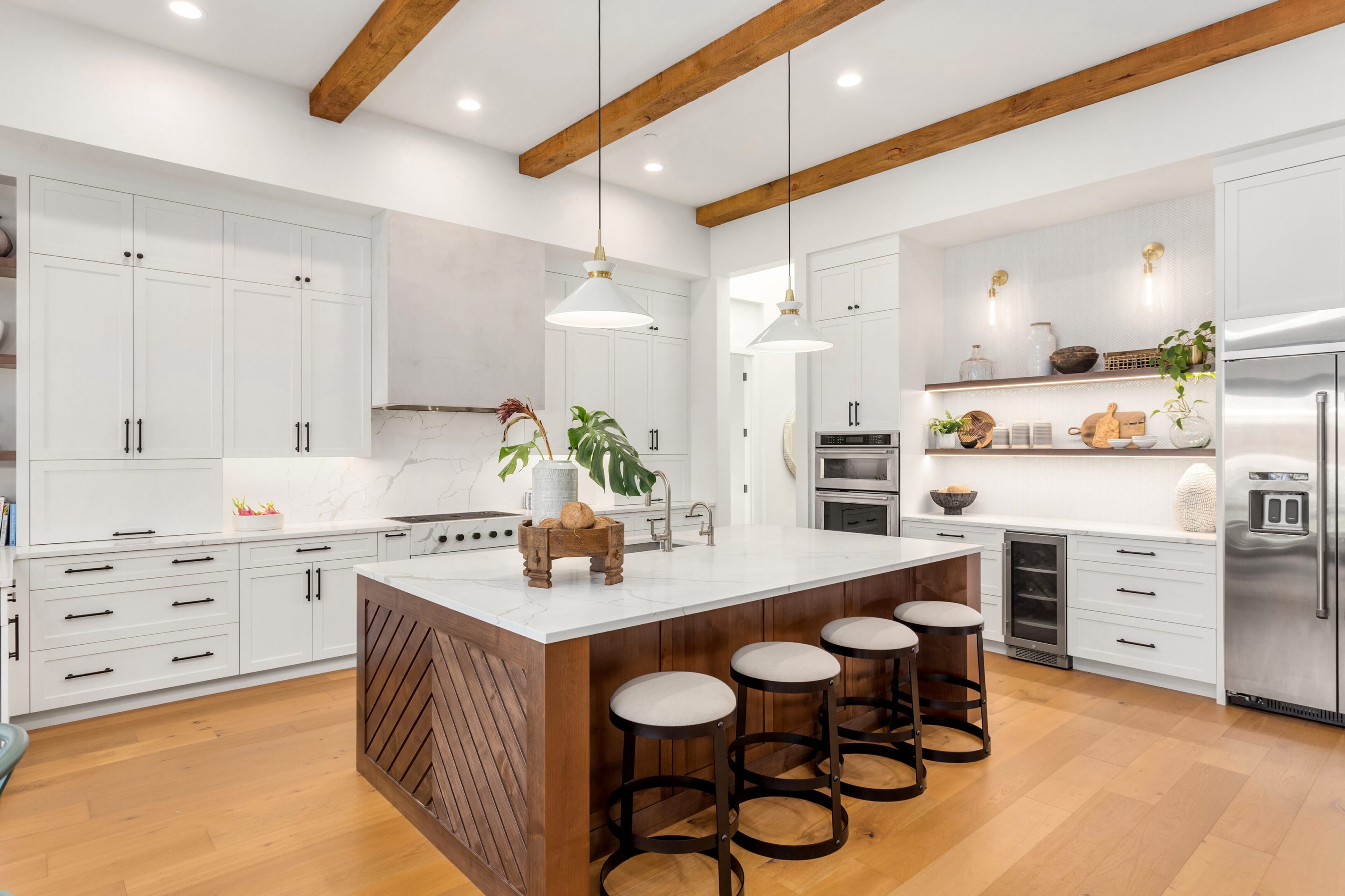 Modern kitchen with island and bar stools.